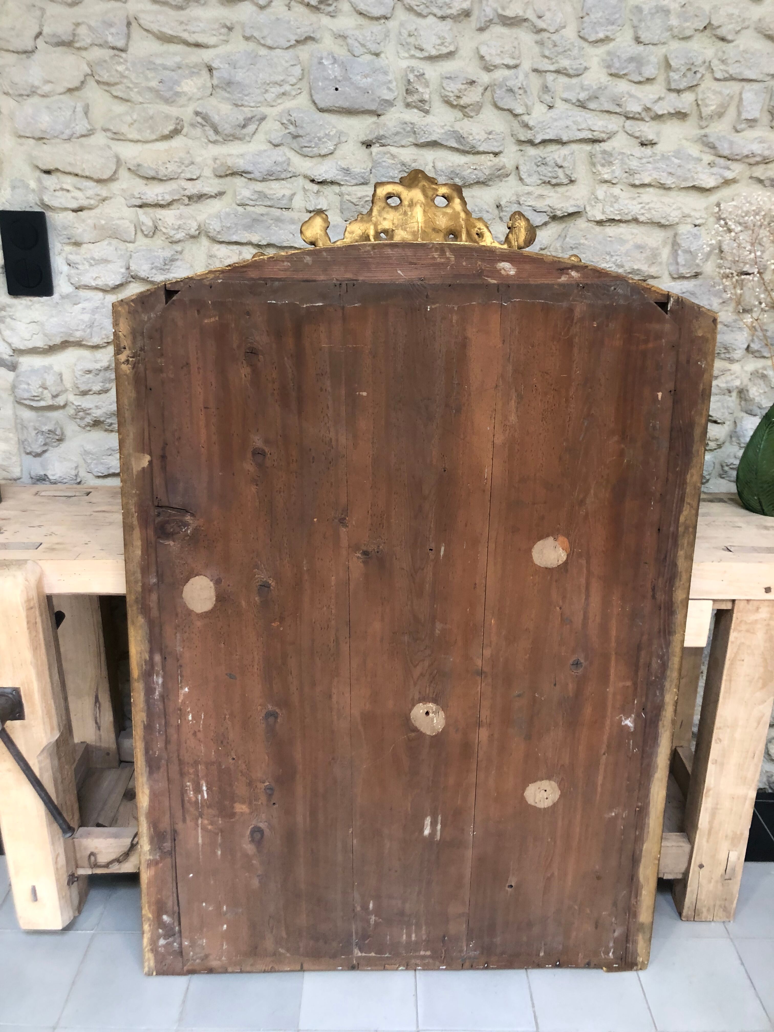 Old mirror 139cm/ 91cm Louis-Philippe with pediment period early 19th, presence of gold leaf.