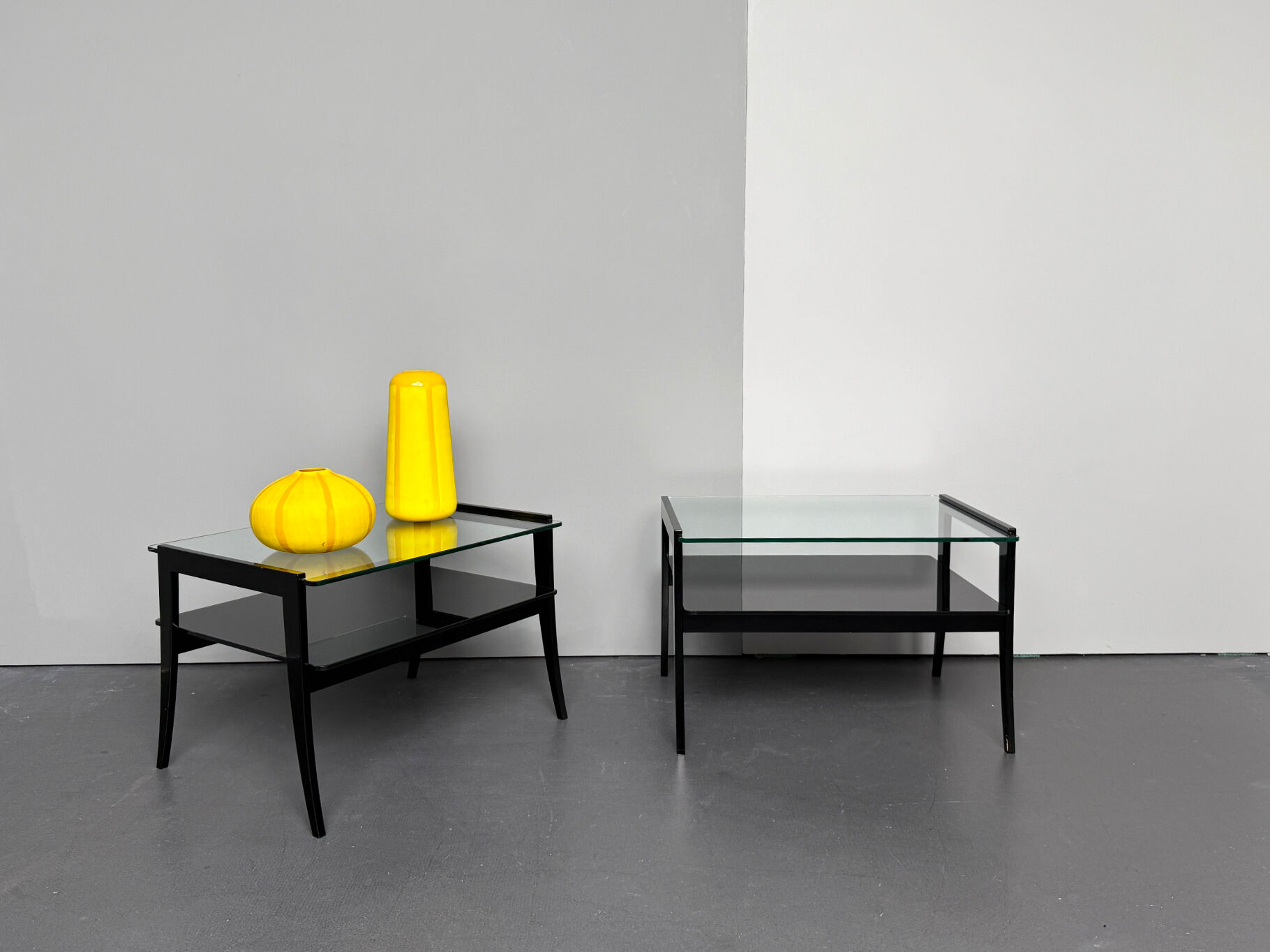 Pair of bedside tables, bedside consoles, black lacquer with glass tops, Italy, 1970s