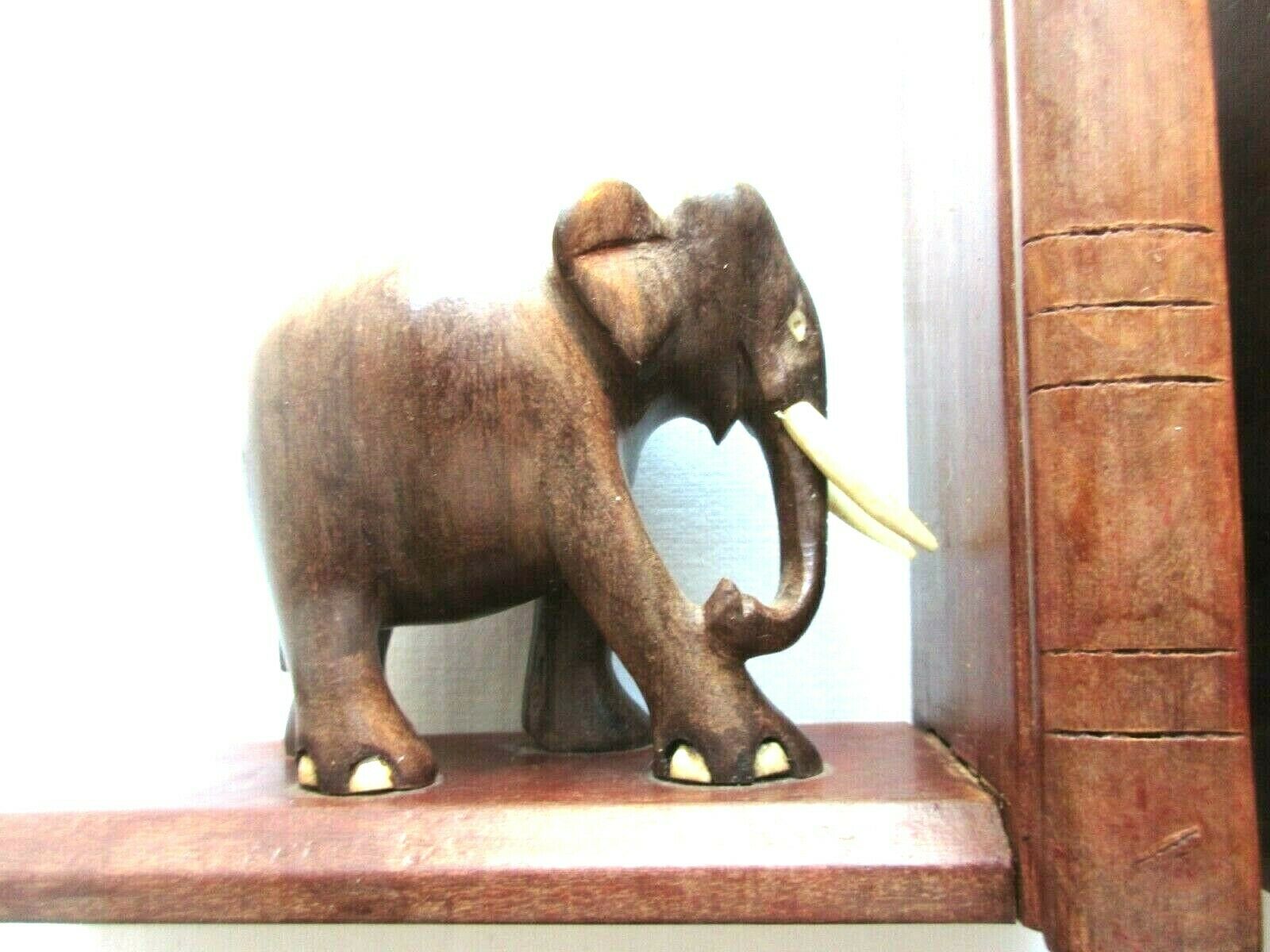 Art Deco bookends wooden elephants and bones on wooden terrace, book shape