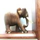 Art Deco bookends wooden elephants and bones on wooden terrace, book shape