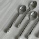 5 small twisted silver metal teaspoons