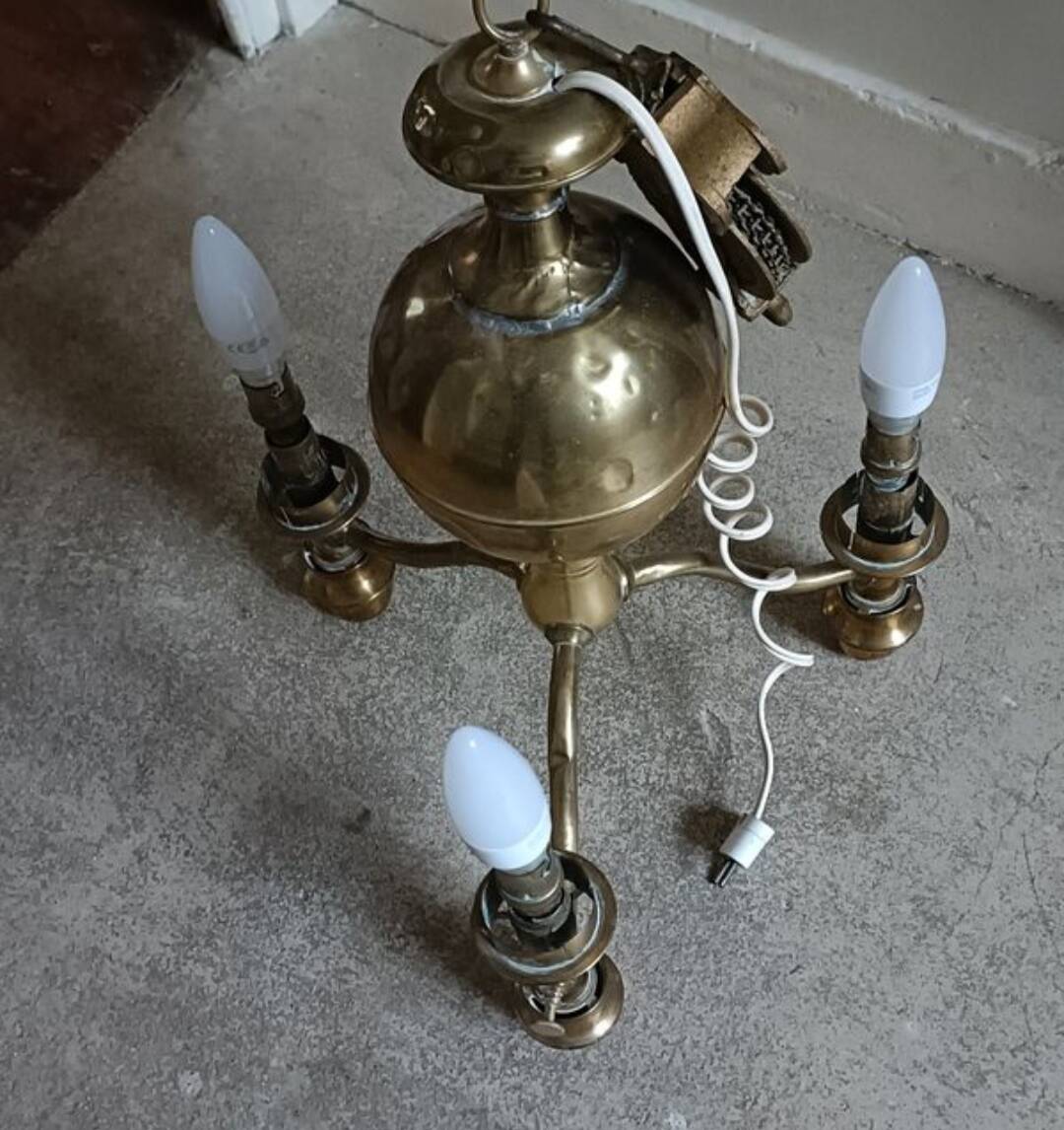 Brass chandelier with three flames.