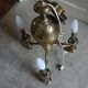 Brass chandelier with three flames.