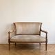 Louis XVI style antique canapé in wood and beige fabric.