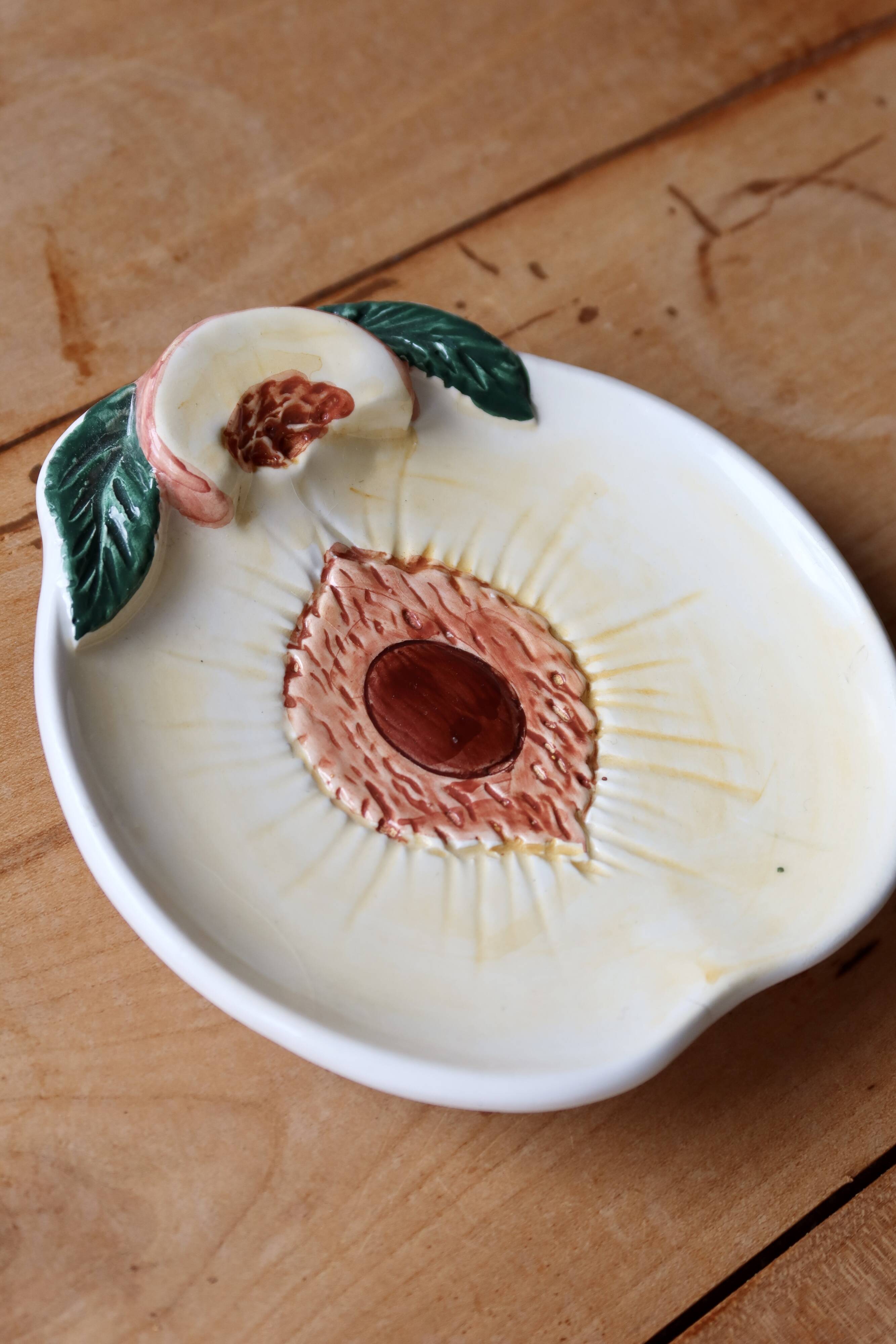 Small vintage barbotine bowl with peach-shaped pattern