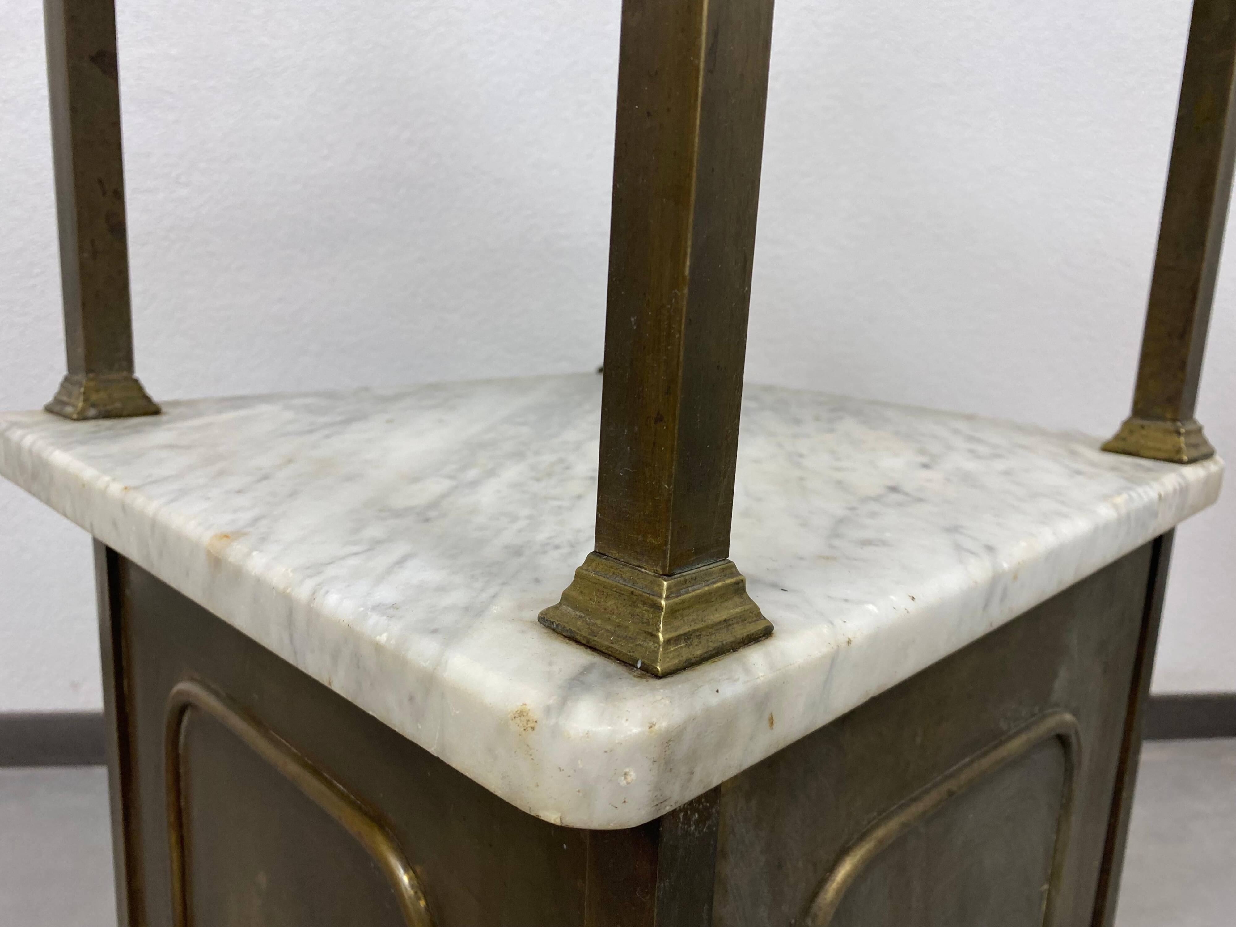 Brass bedside table with a marble top.