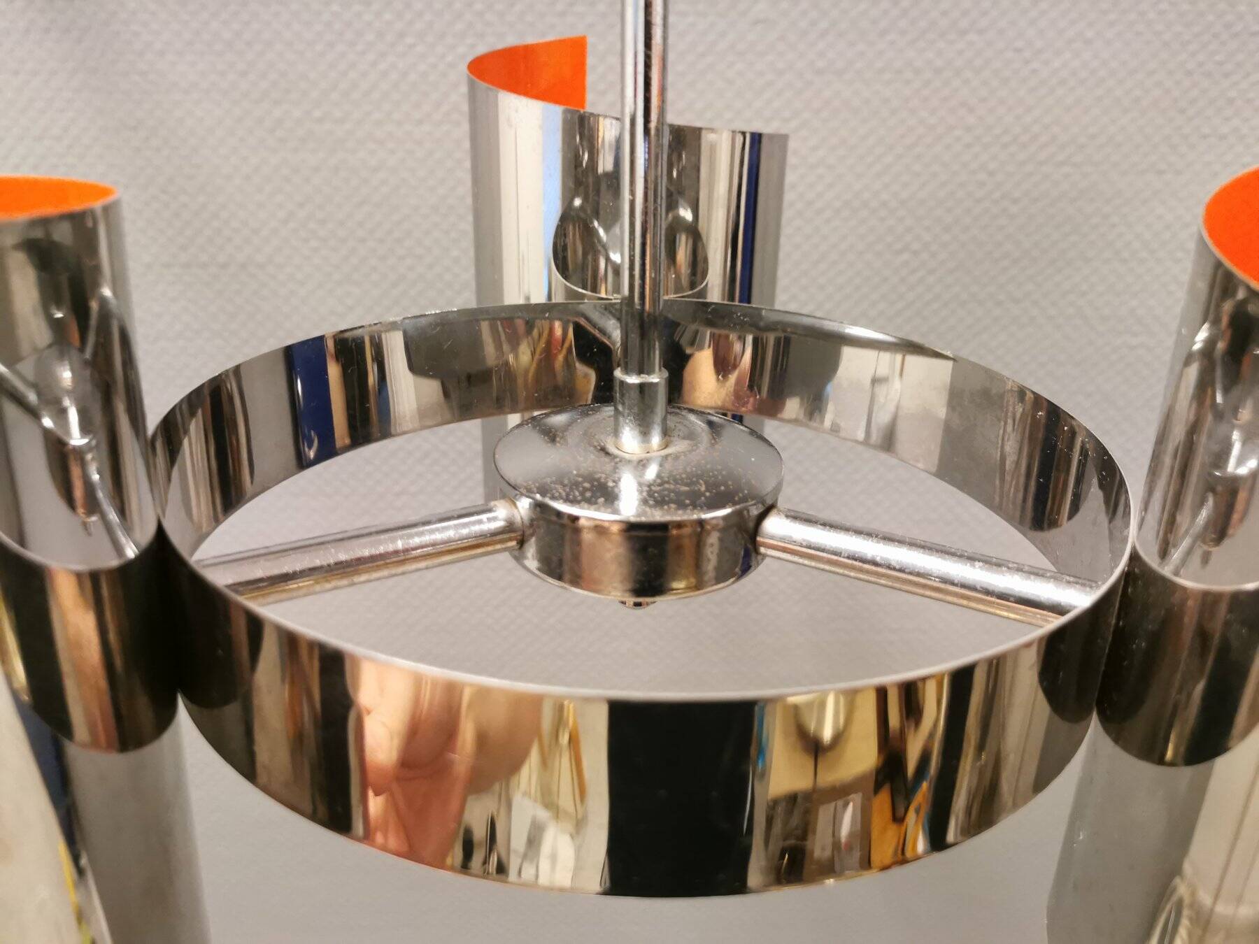 Hanging lamp in chromed metal with orange contrast lacquer and three light sources.