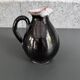 Antique black pitcher with white collar
