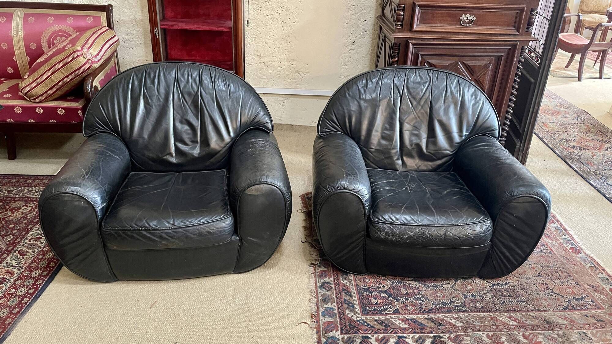 Pair of black leather club armchairs, twentieth century