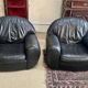 Pair of black leather club armchairs, twentieth century
