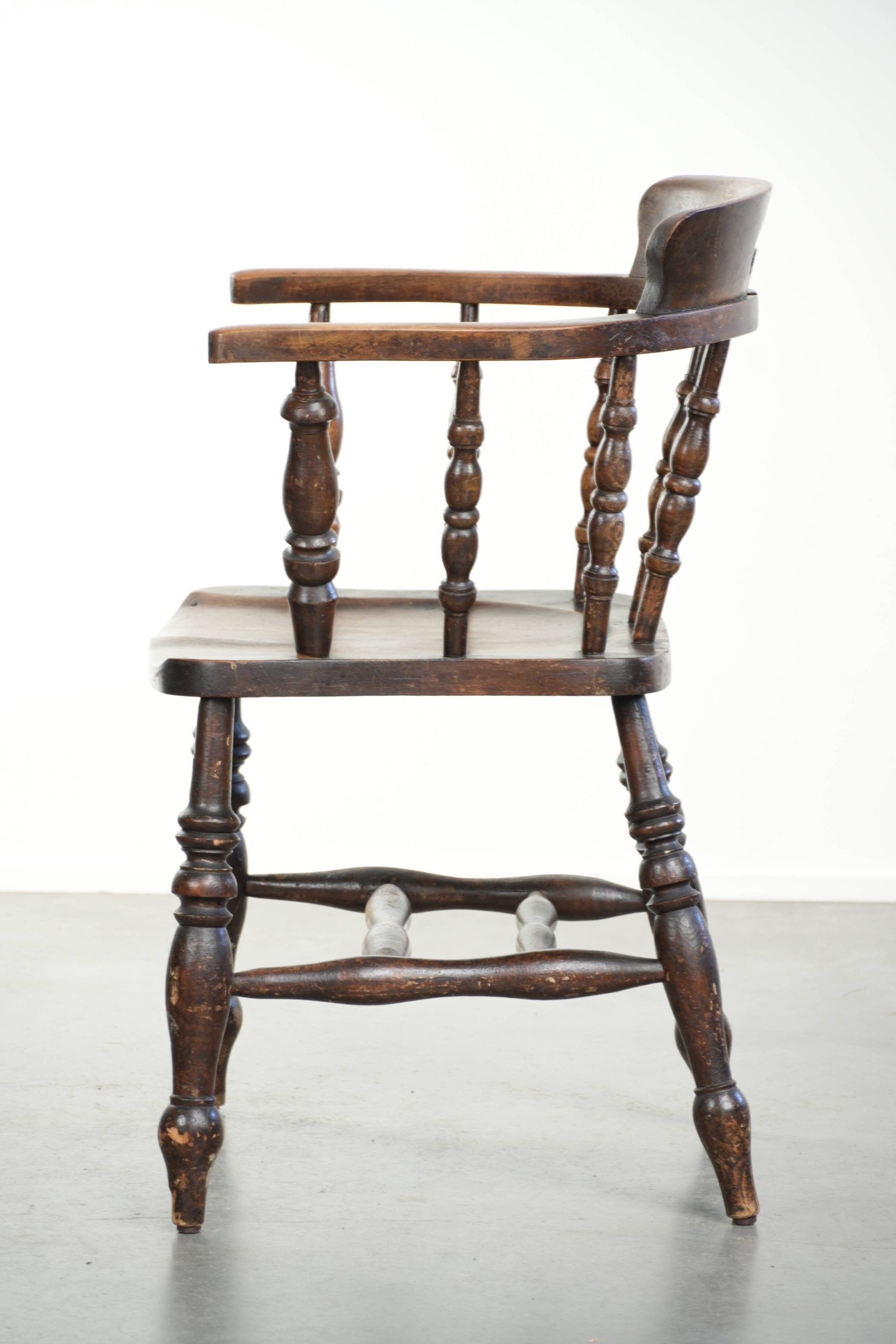 Wooden English antique pub/captain chair from the late 19th century
