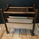 Vintage rattan magazine rack on wheels