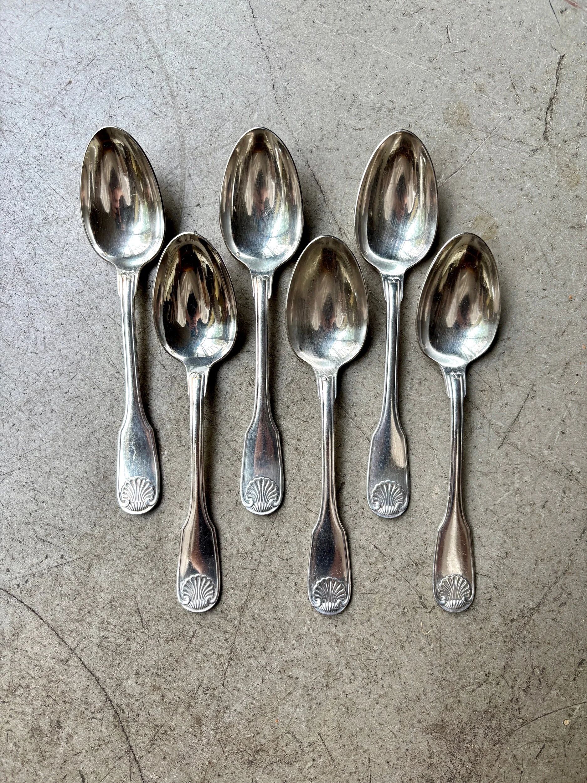 6 large Christofle silver-plated spoons with shell decoration.