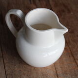 Old pitcher in white earthenware
