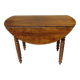 Walnut drop-leaf table with honey spoon legs.