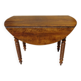 Walnut drop-leaf table with honey spoon legs.