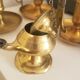 Many candlesticks and a small oil lamp.