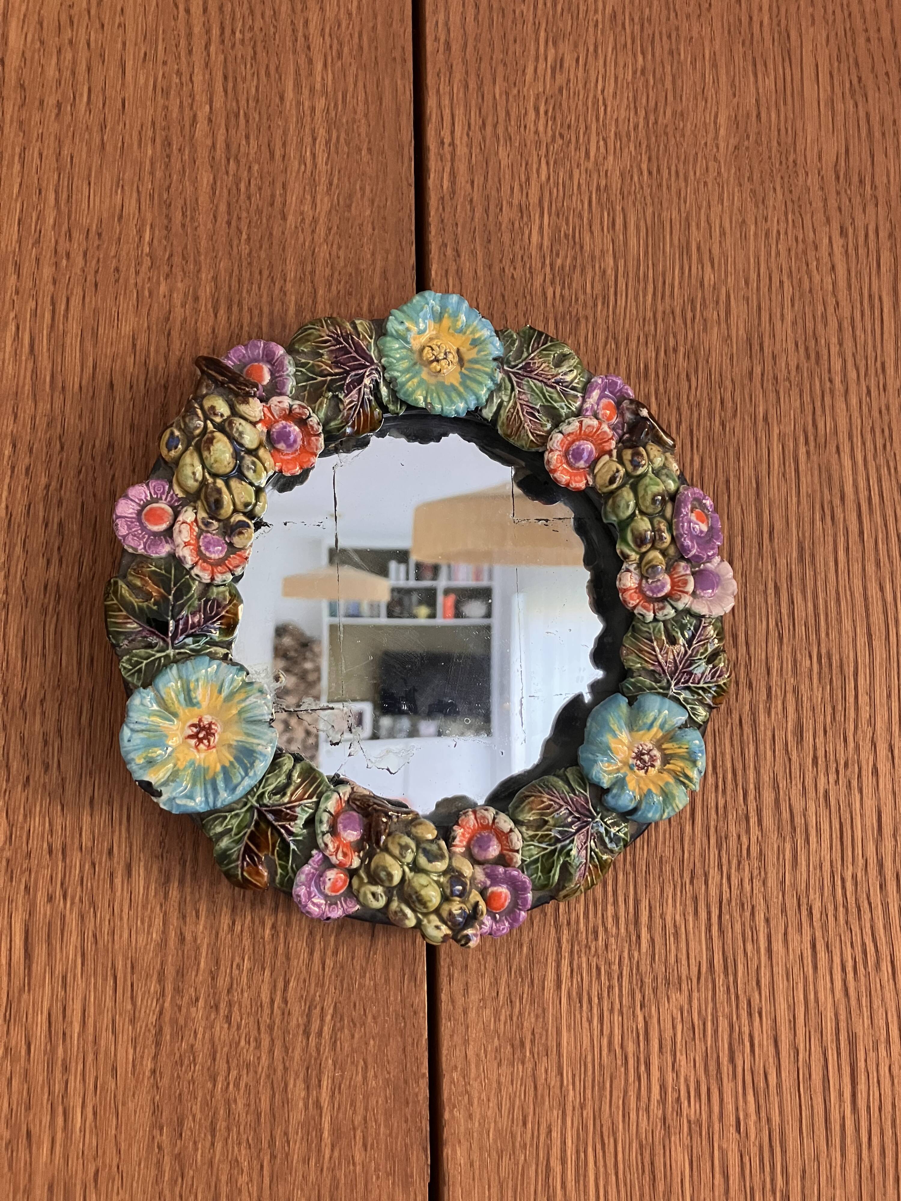 Round wall mirror in ceramic with slip-cast flowers, glazed, from the 60s/70s.