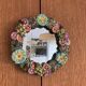 Round wall mirror in ceramic with slip-cast flowers, glazed, from the 60s/70s.