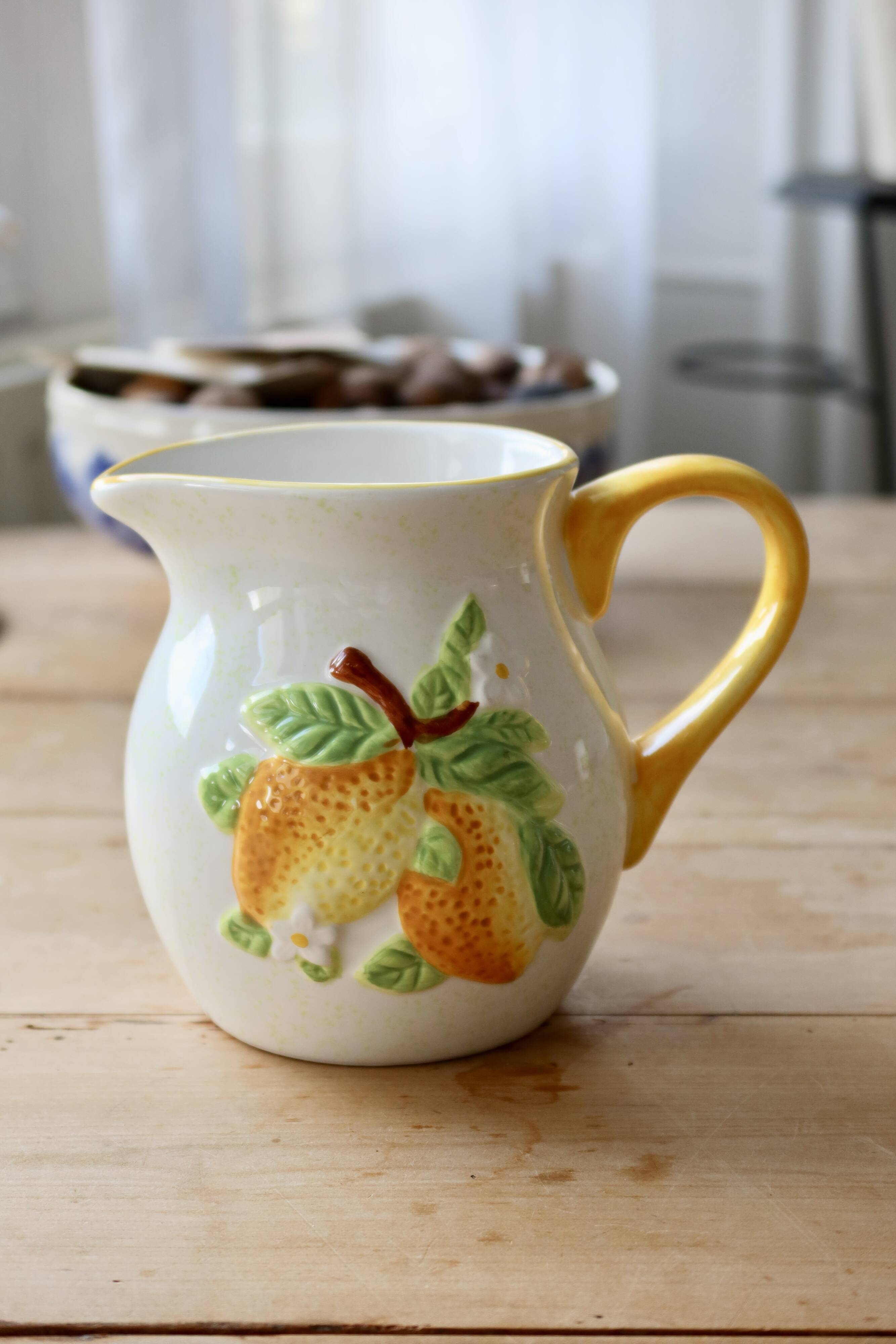 Vintage earthenware and slip pitcher with lemon motif