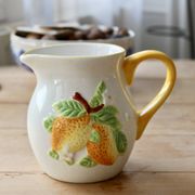 Vintage earthenware and slip pitcher with lemon motif