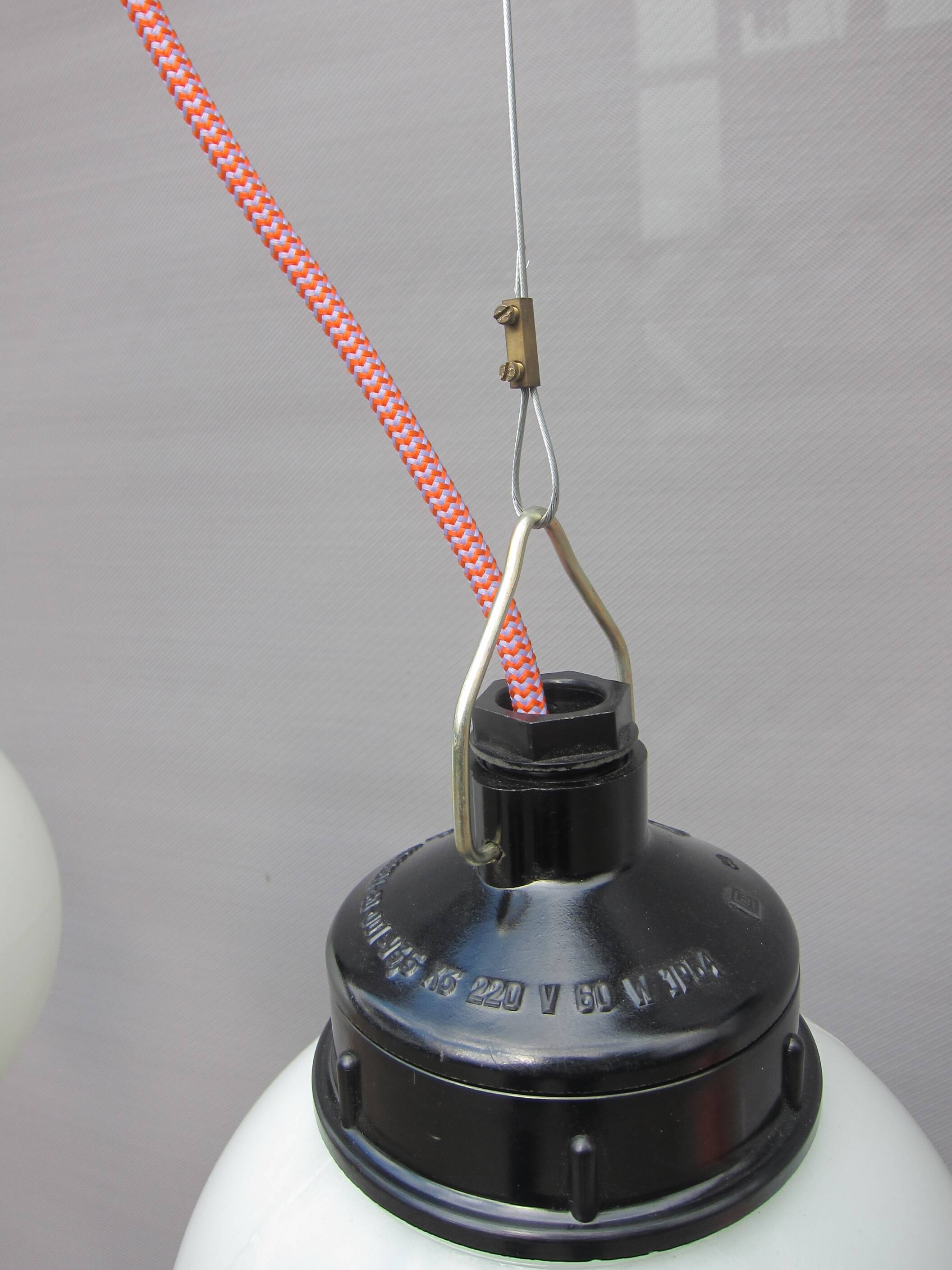 Trio of opal glass and bakelite globe pendant lights