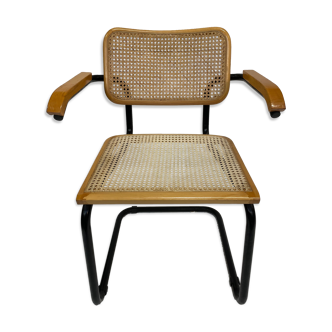 Cesca model chair designed by Marcel Breuer with black-framed armrests