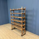 Old wooden workshop shelf with cast iron wheels.