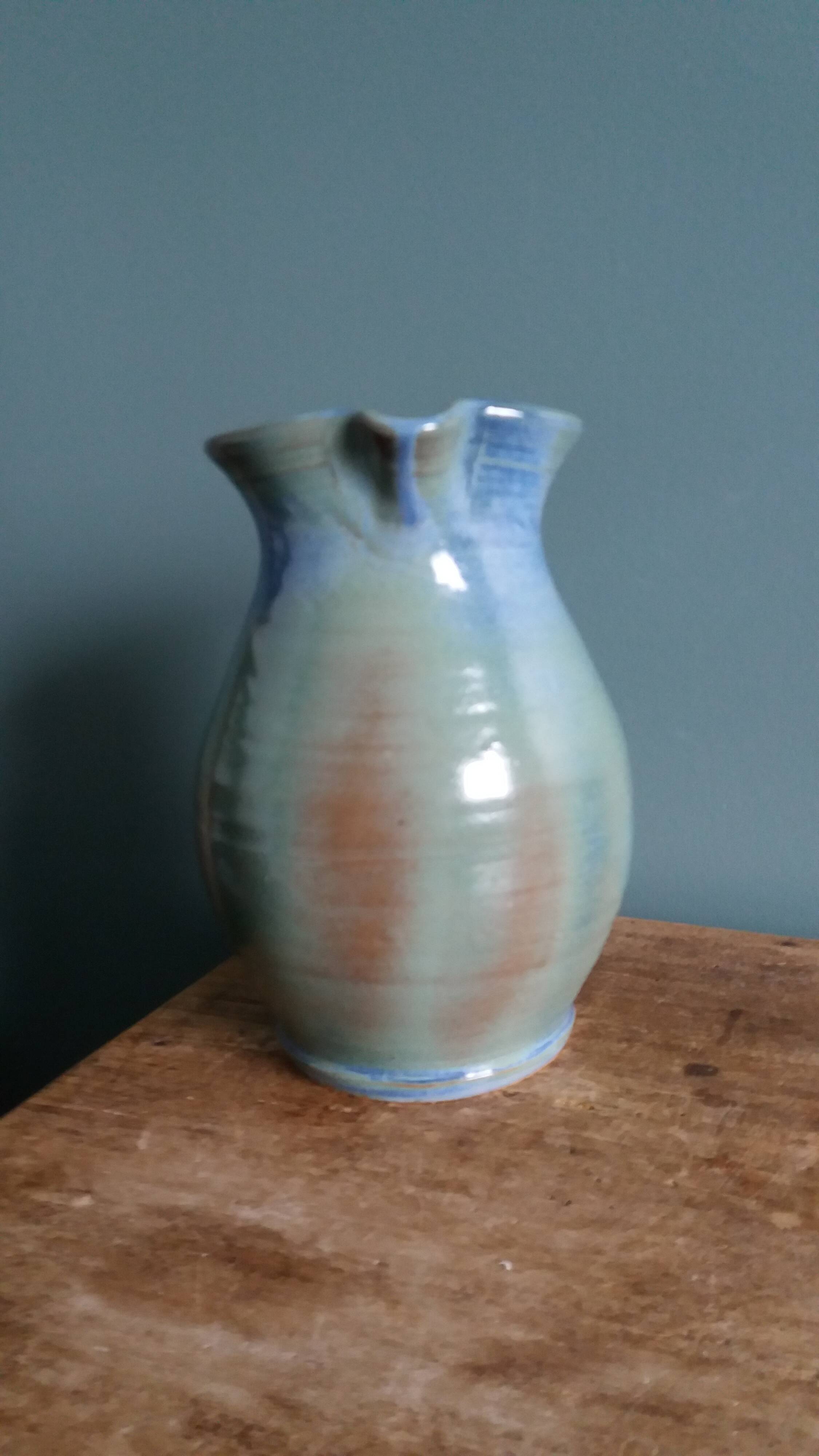 Enamel pitcher in pastel blue and green, signed
