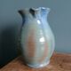 Enamel pitcher in pastel blue and green, signed
