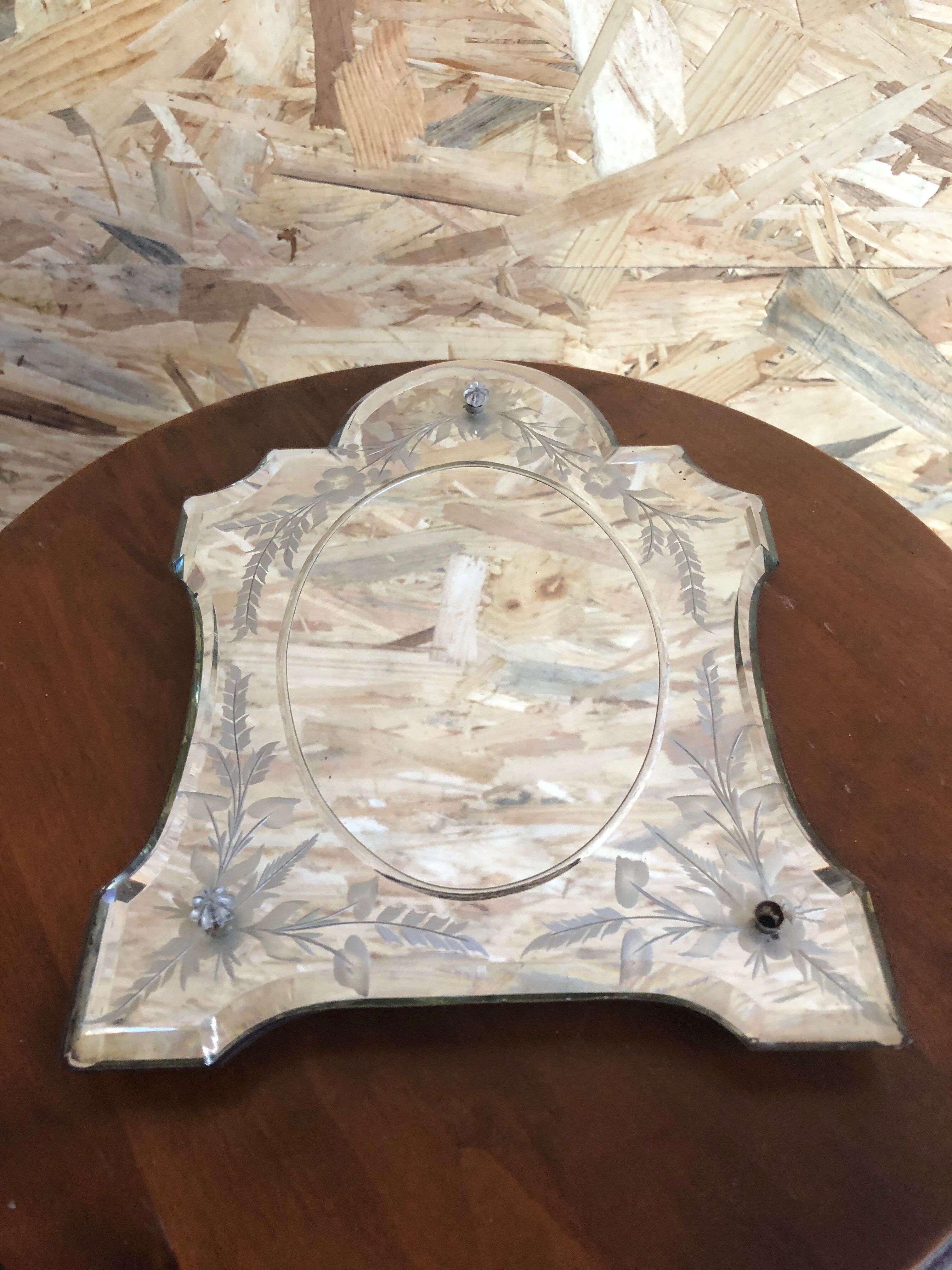 Old beveled Venetian mirror with engraved flower decoration