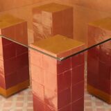 Modern coffee table in burgundy zellige with a tempered glass top.