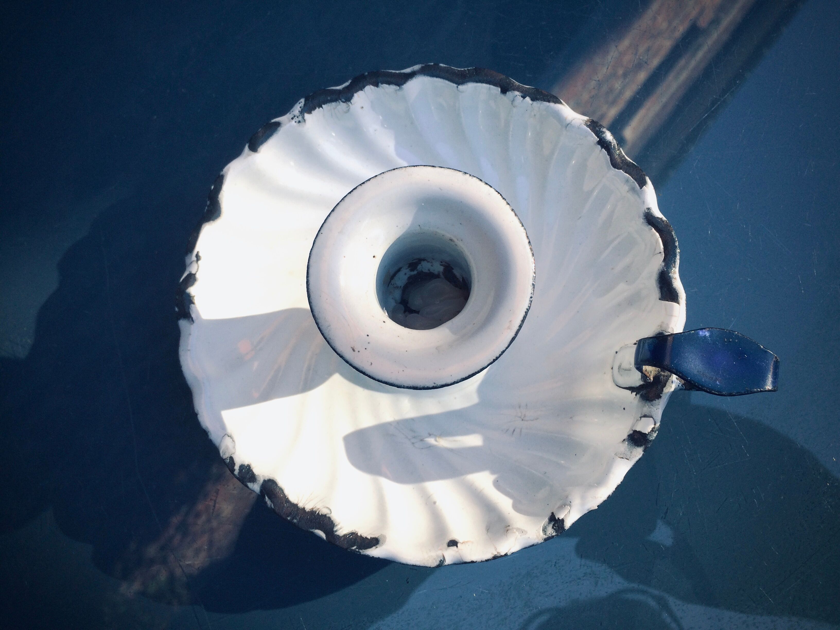 Old white enamelled candlestick