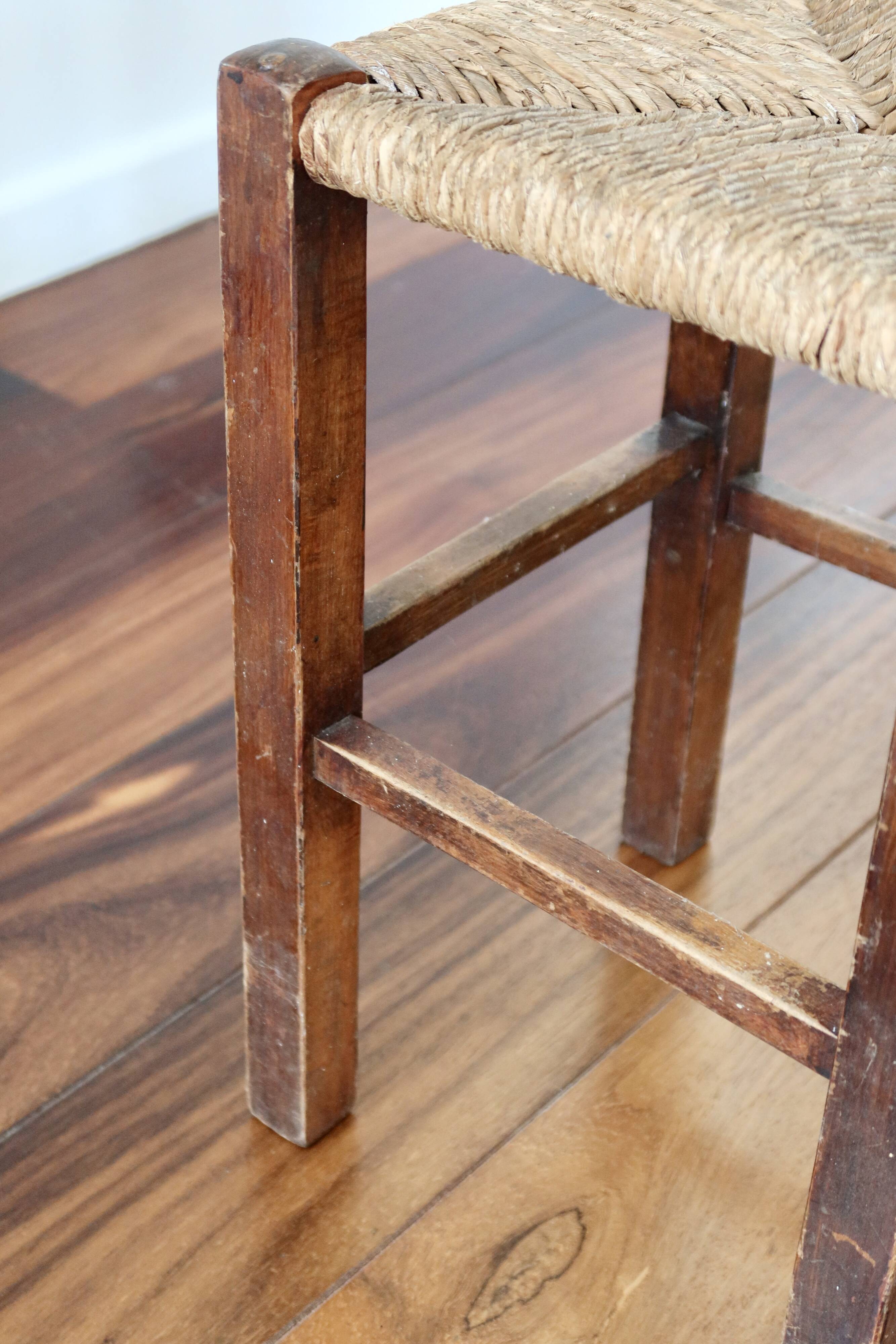 Rustic old stool made of wood and straw.