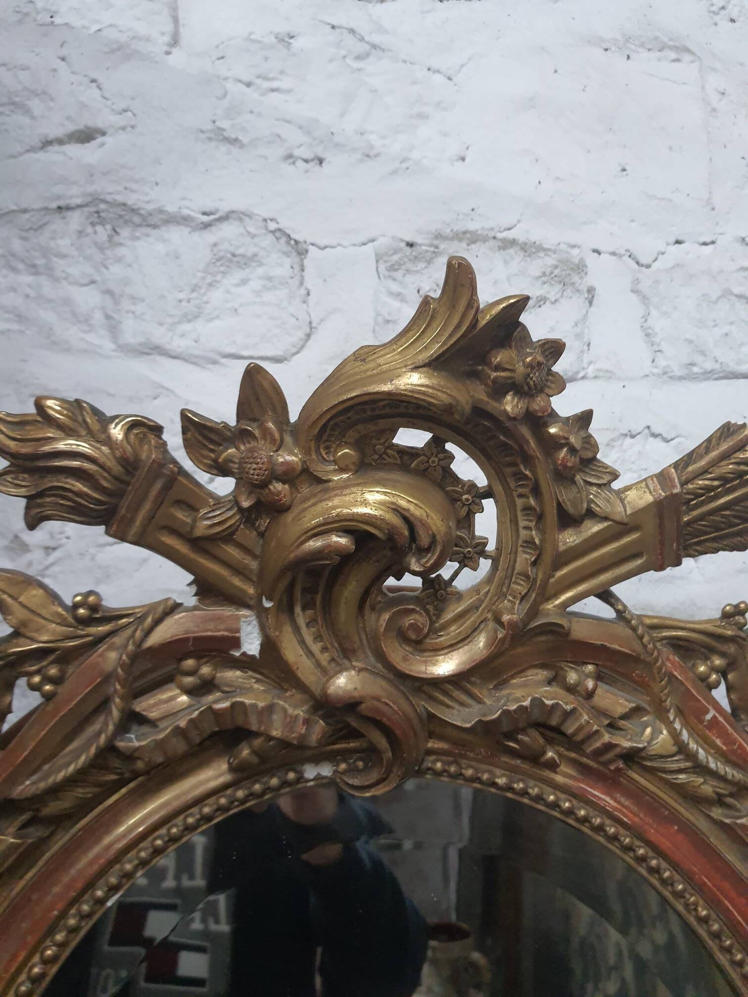 Golden oval mirror