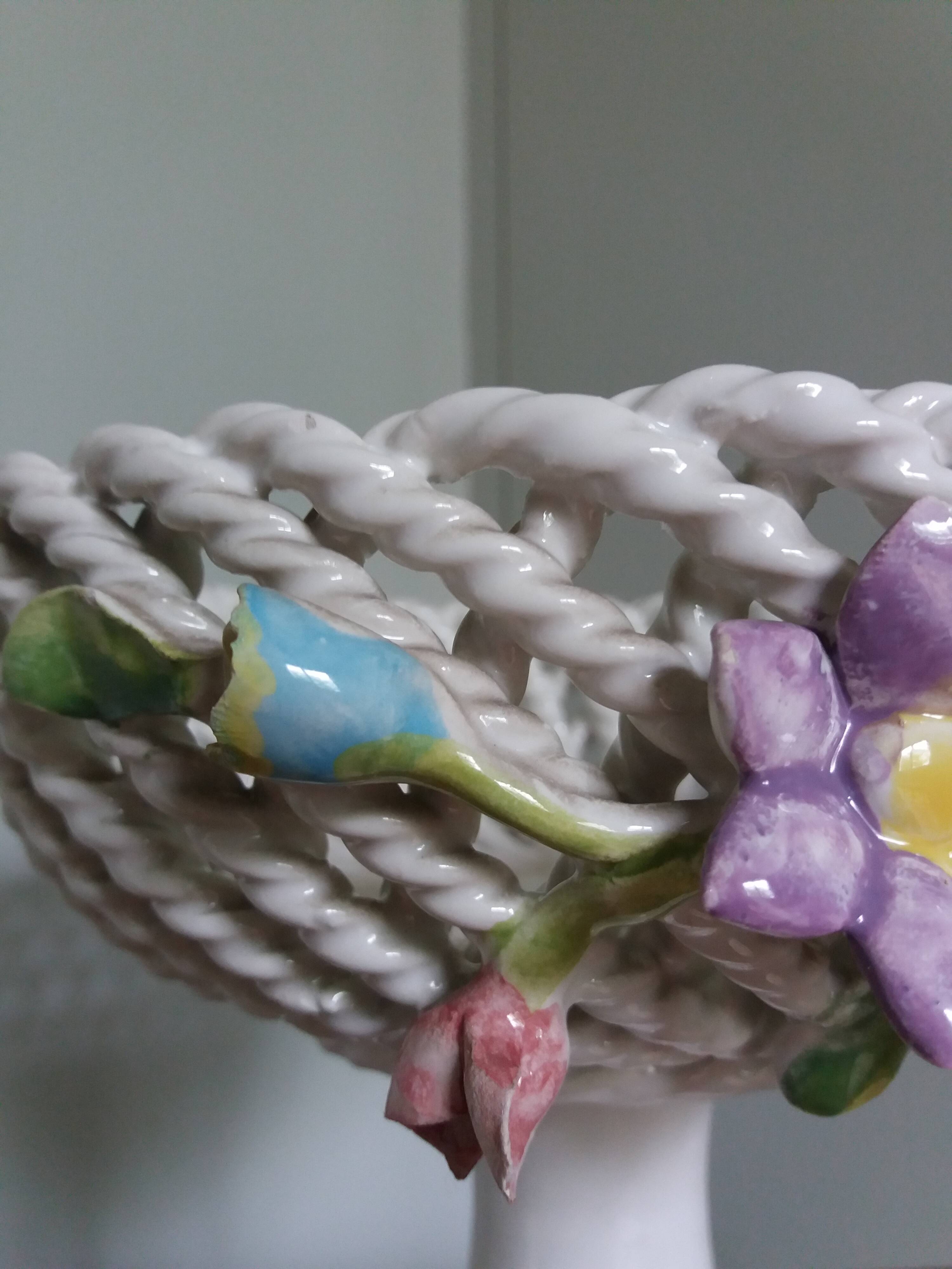 Cup on woven ceramic base with slip flowers