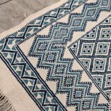 White and blue hand-woven rug in natural wool