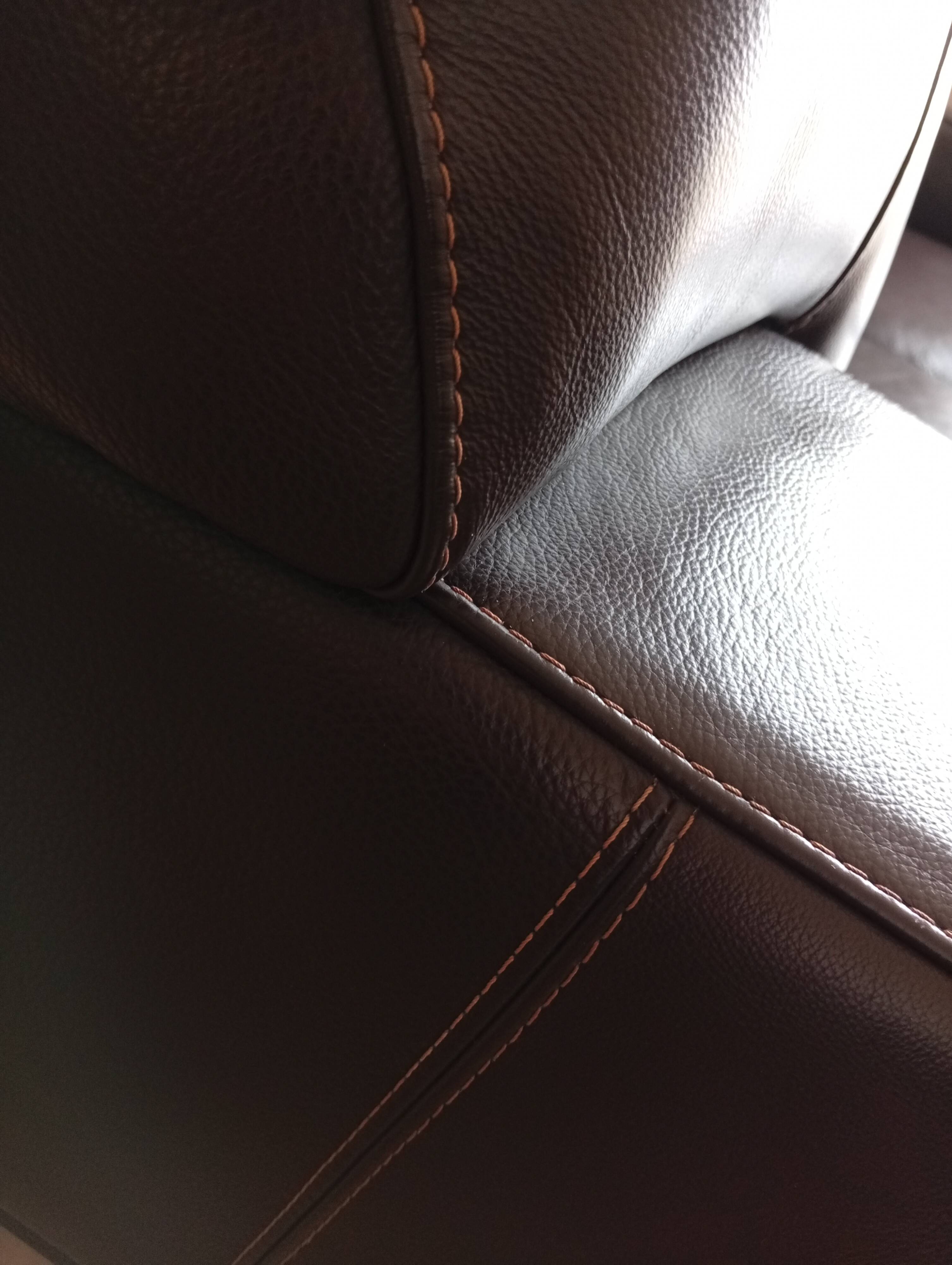 Two brown leather Crozatier two-and-a-half-seater sofas.