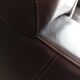 Two brown leather Crozatier two-and-a-half-seater sofas.