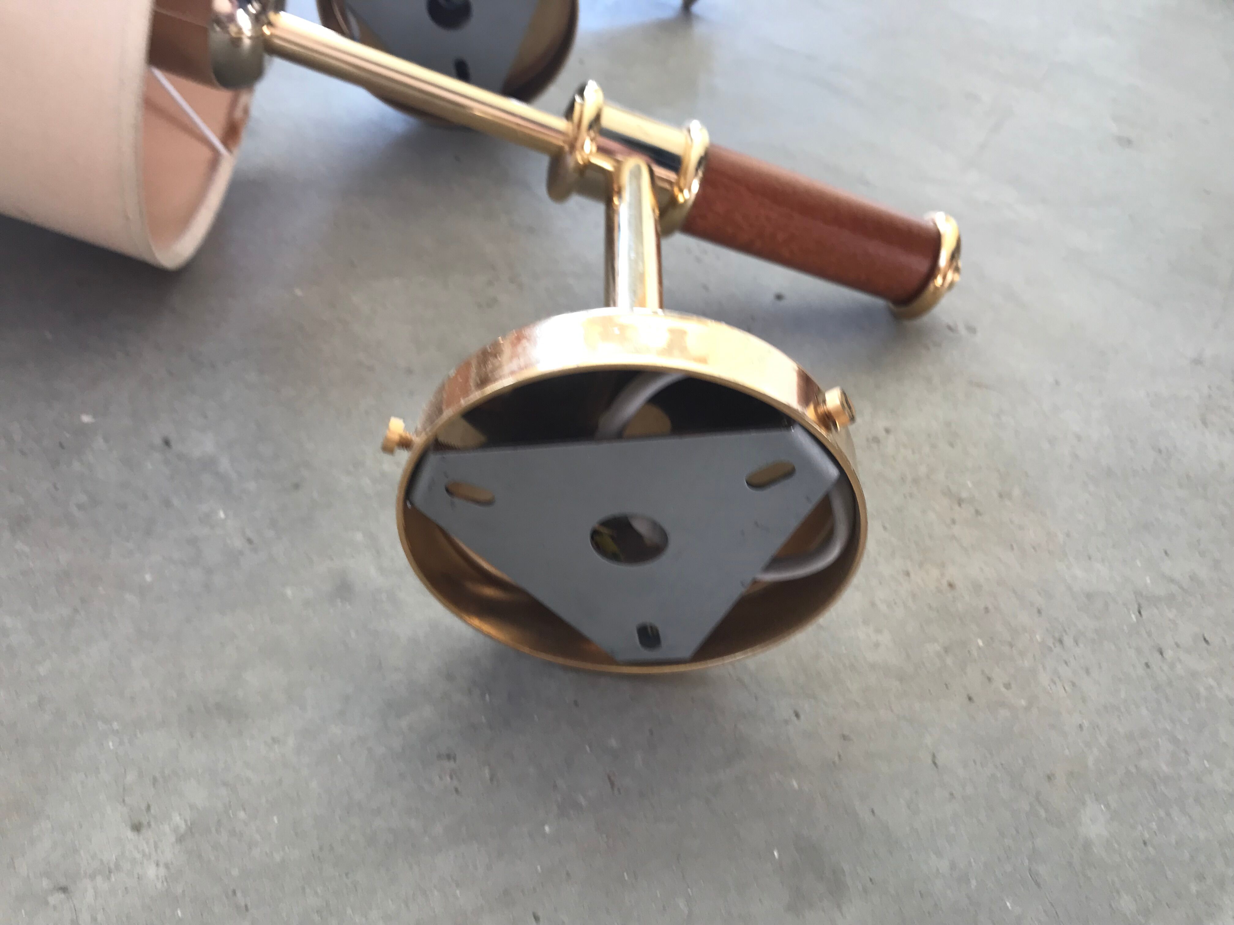 Pair of modernist sconces in wood and gilded metal.