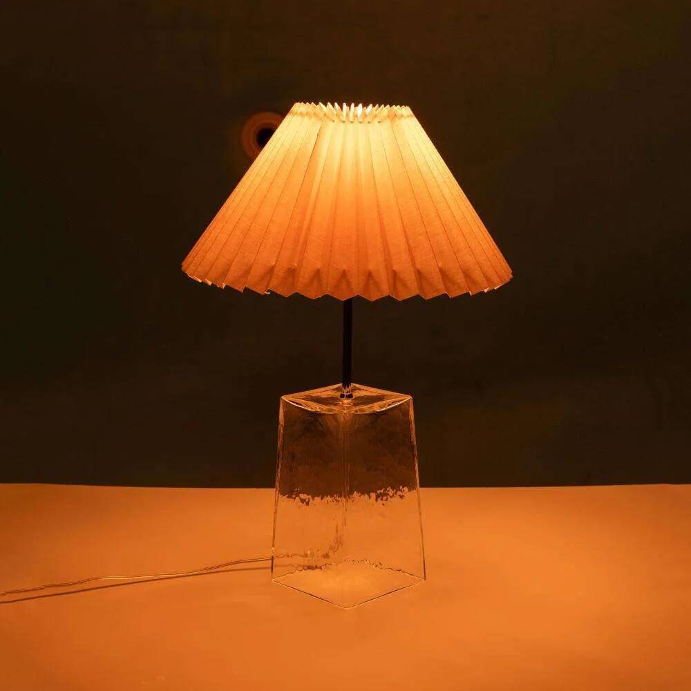 Minimalist glass table lamp from the 80s with a pleated shade.