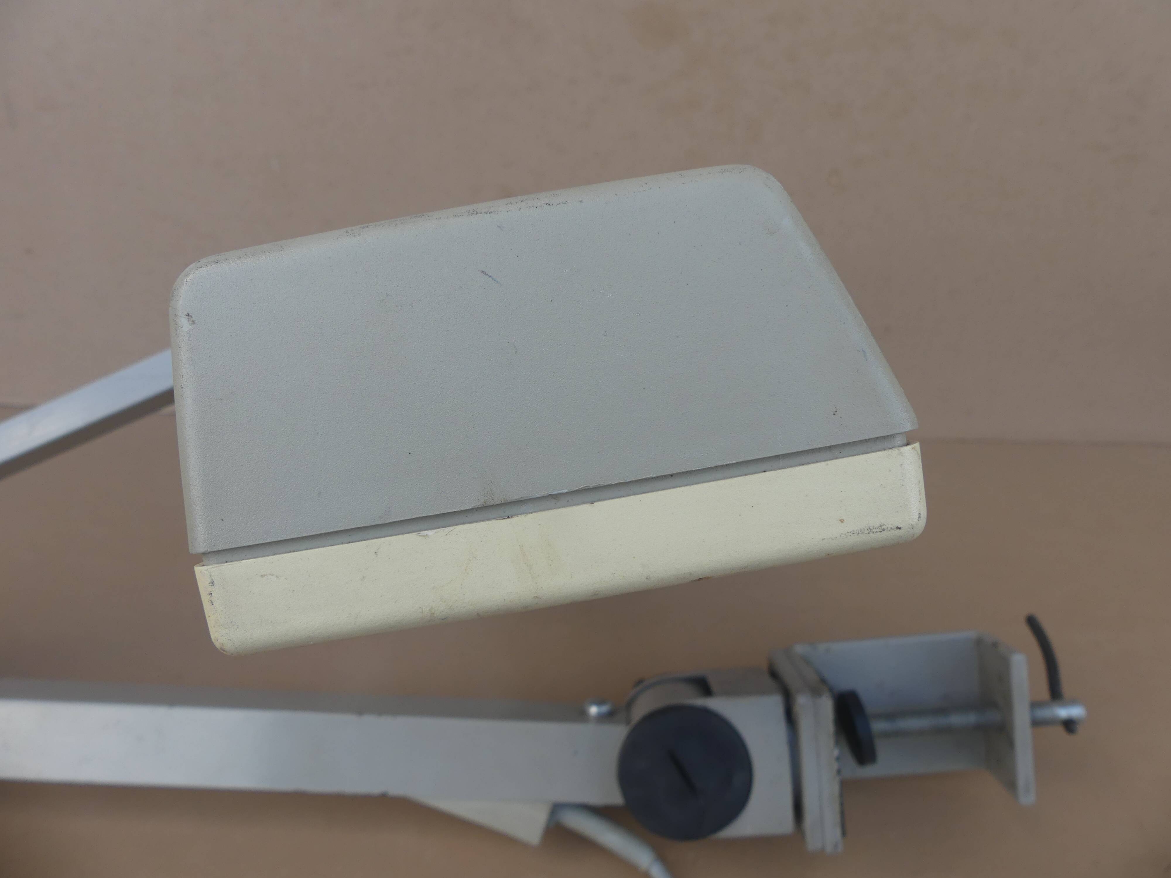 WALDMANN articulated workshop lamp with two industrial clamp arms for architects.