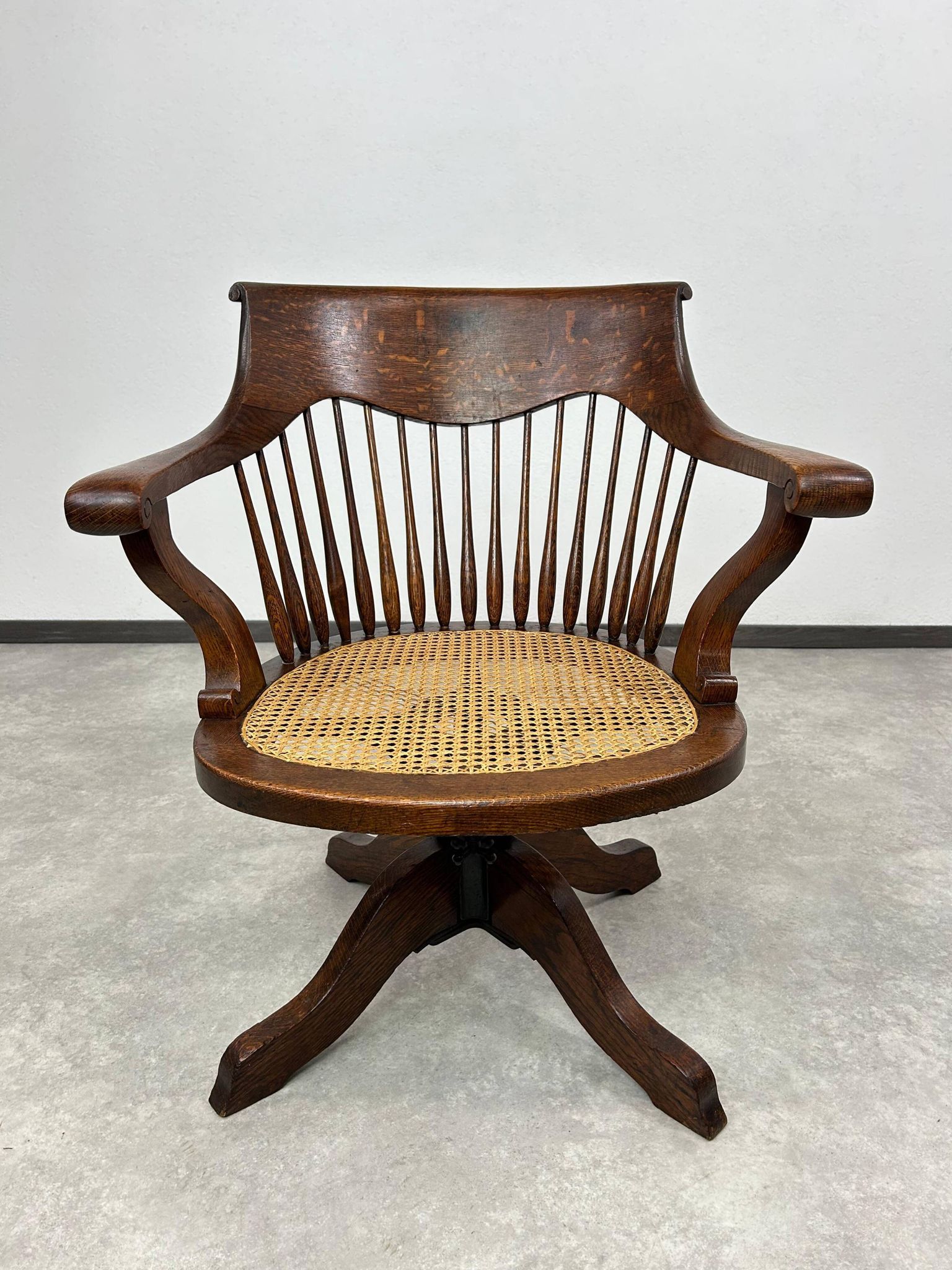 Swivel office chair in oak with a rattan seat.
