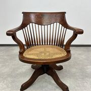Swivel office chair in oak with a rattan seat.