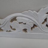 Decorative pediment in white carved wood