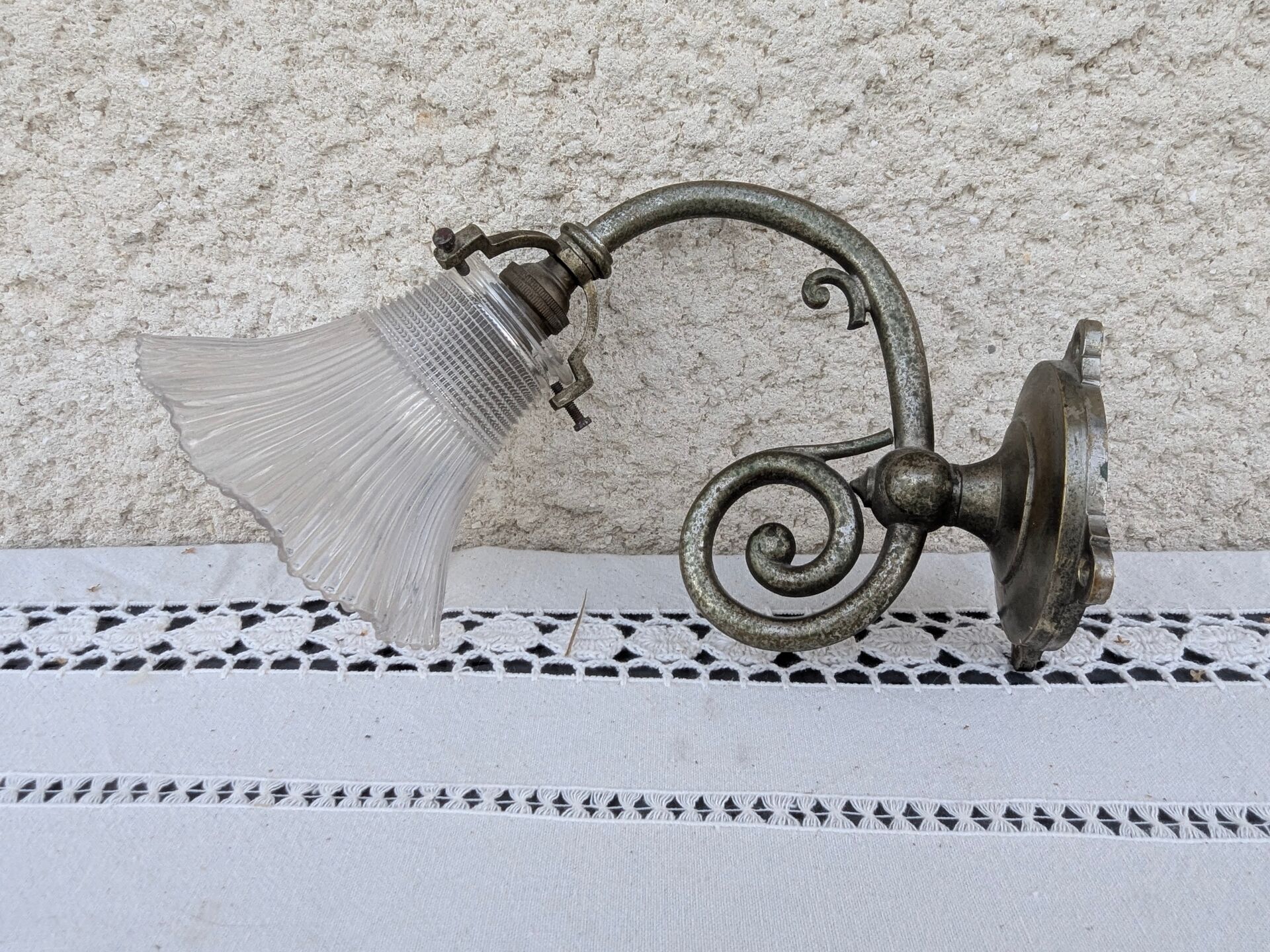 Vintage wall sconce in brass with Holophane glass tulip.