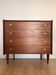 Teak chest of drawers with gold handles