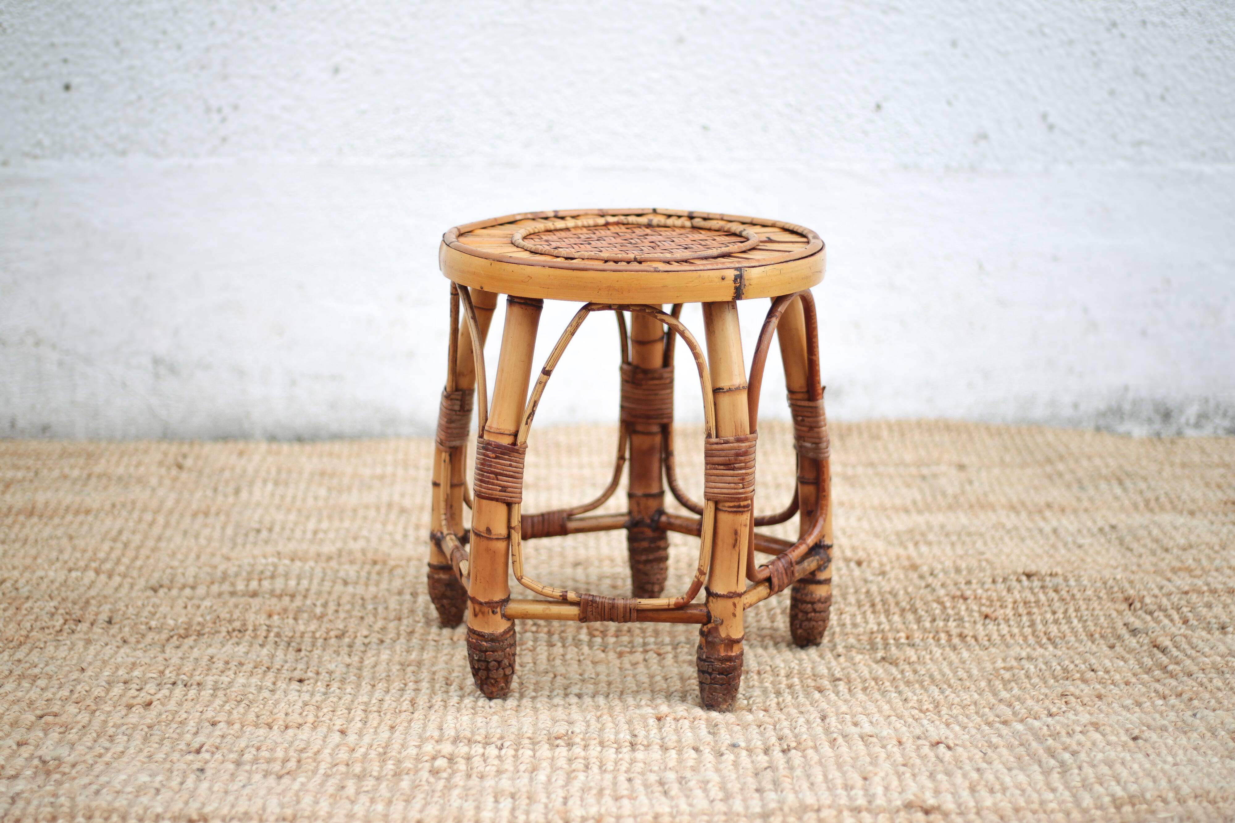 Vintage bamboo stool, woven rattan plant stand, interior decoration.