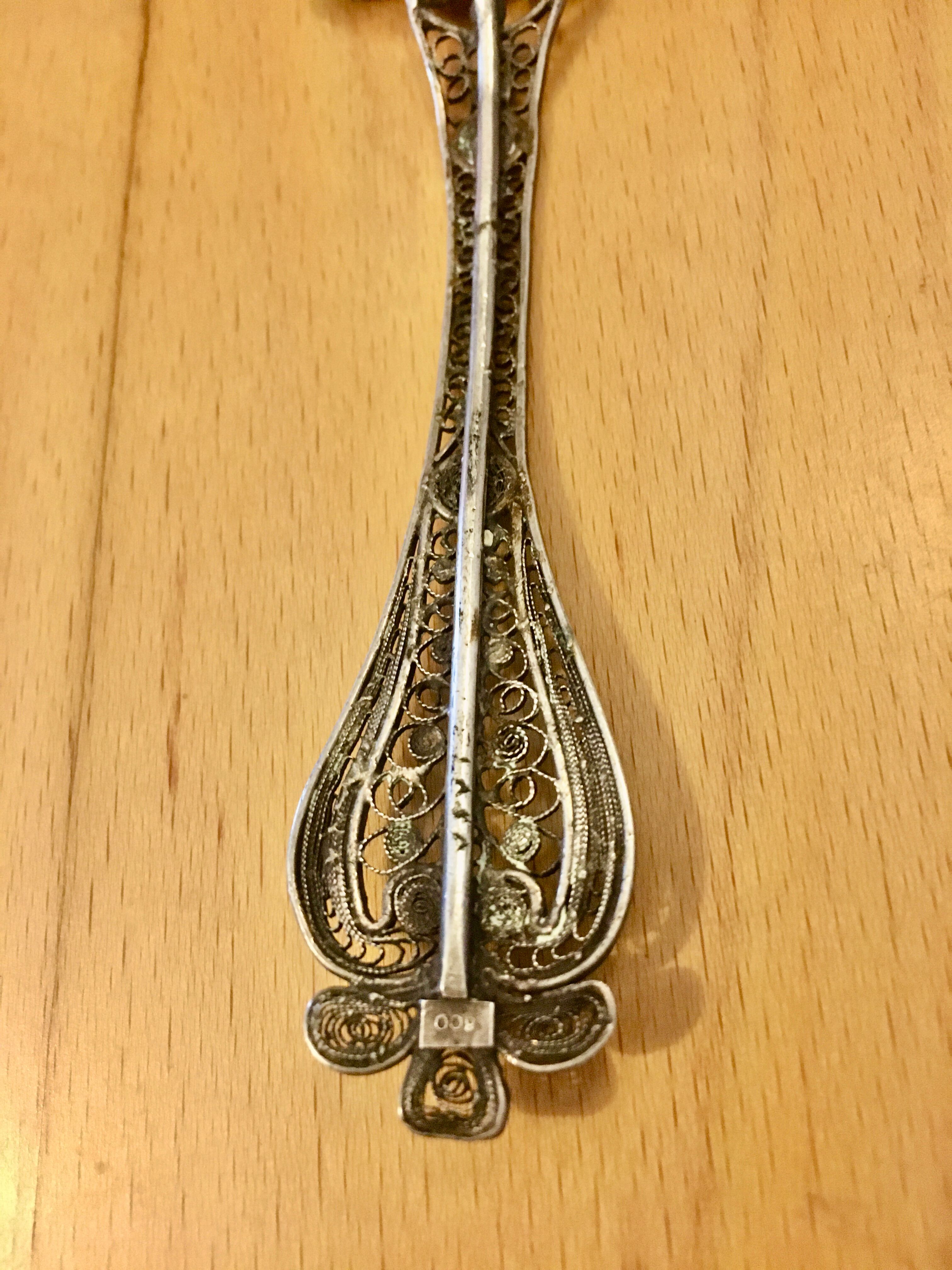 silver sprinkler spoon