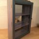 Display shelf with miniature blue wood and mirrors